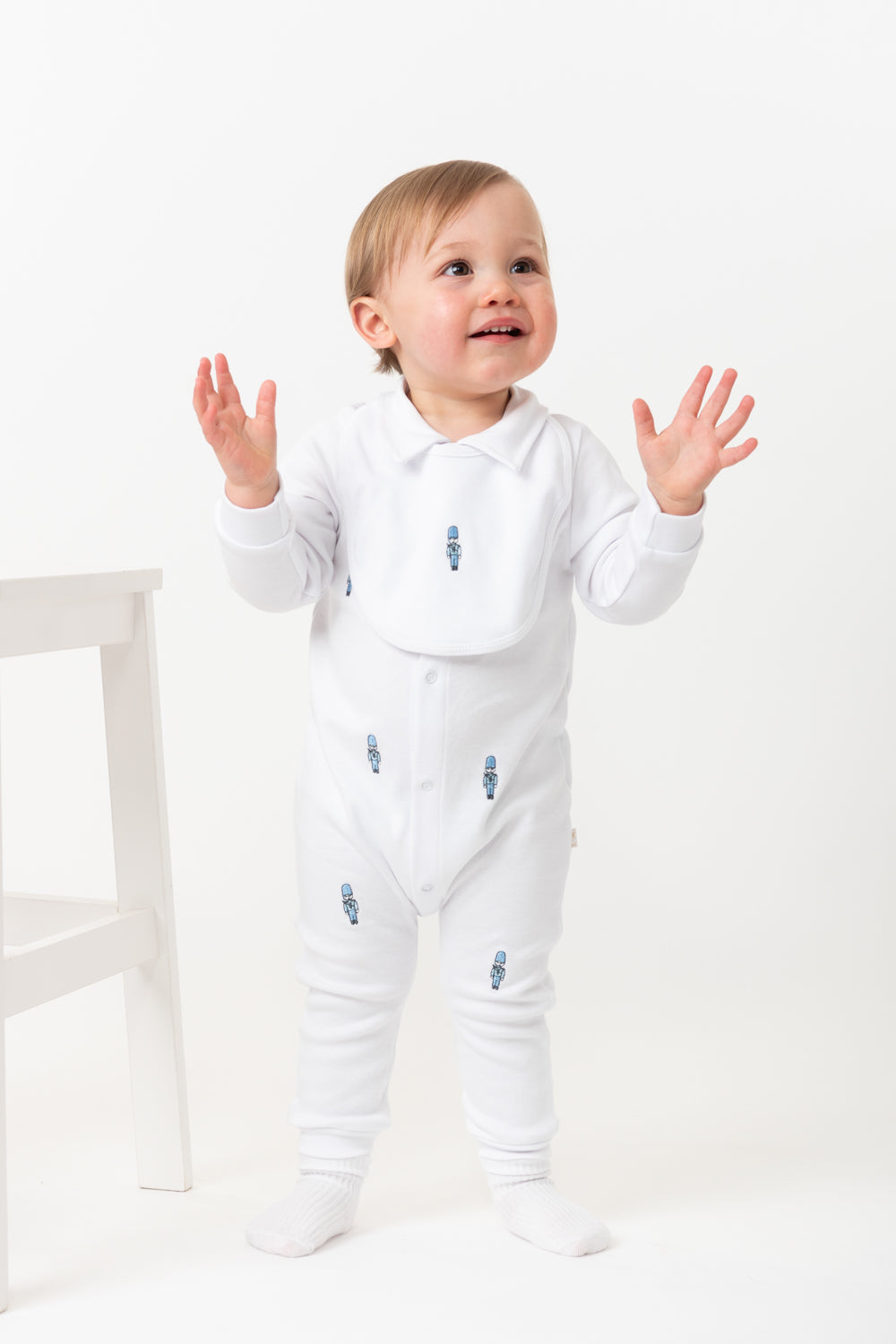 White Baby Romper with Embroidered Soldiers and Matching Bib