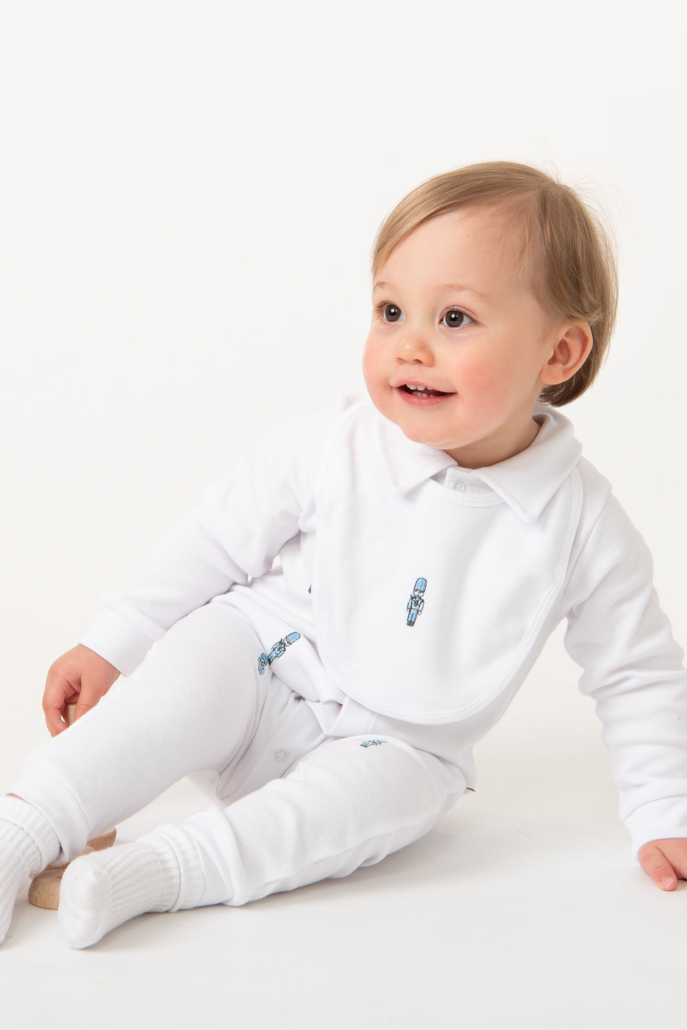 White Baby Romper with Embroidered Soldiers and Matching Bib