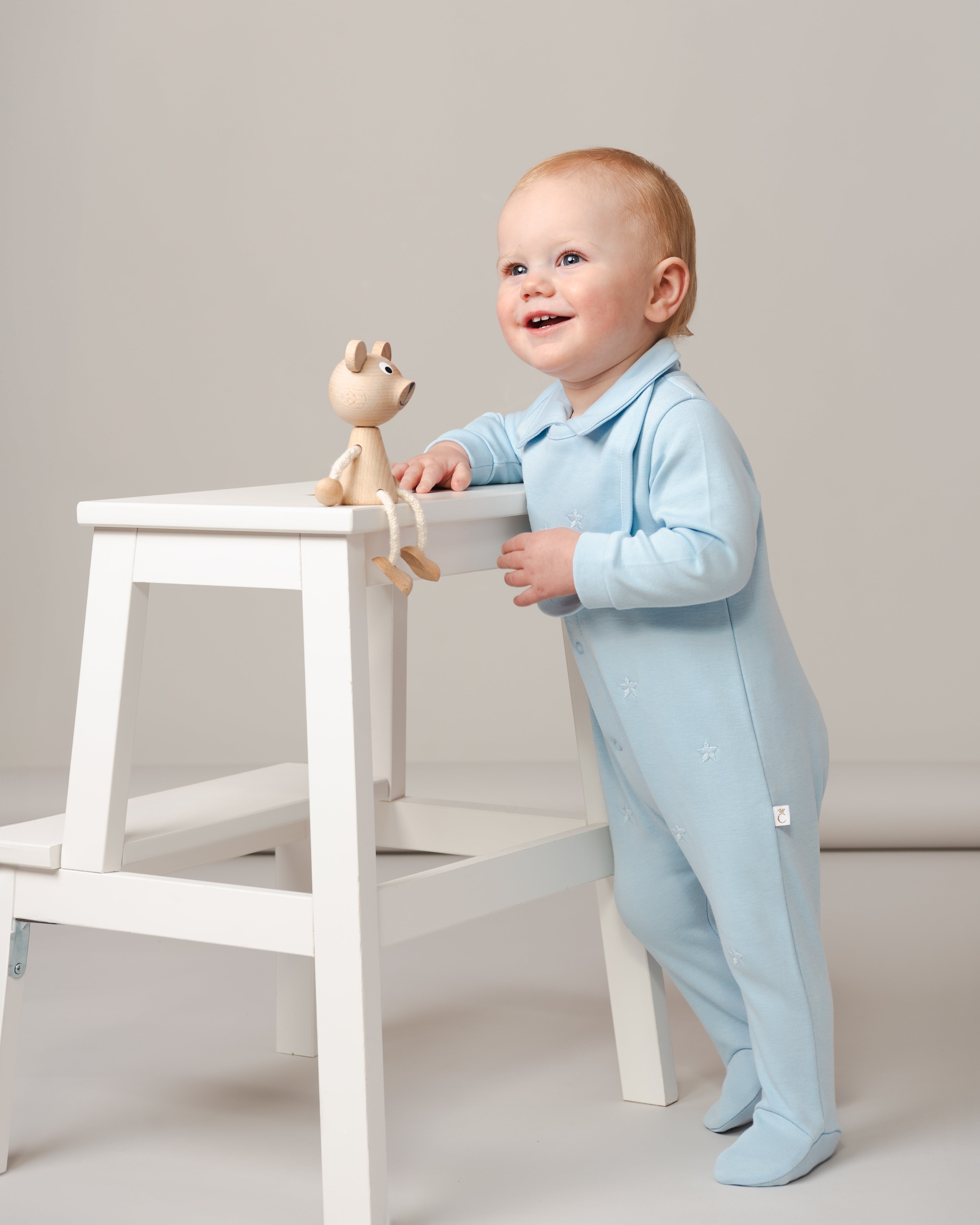 Sky Blue Baby Romper with Embroidered Stars and Matching Bib