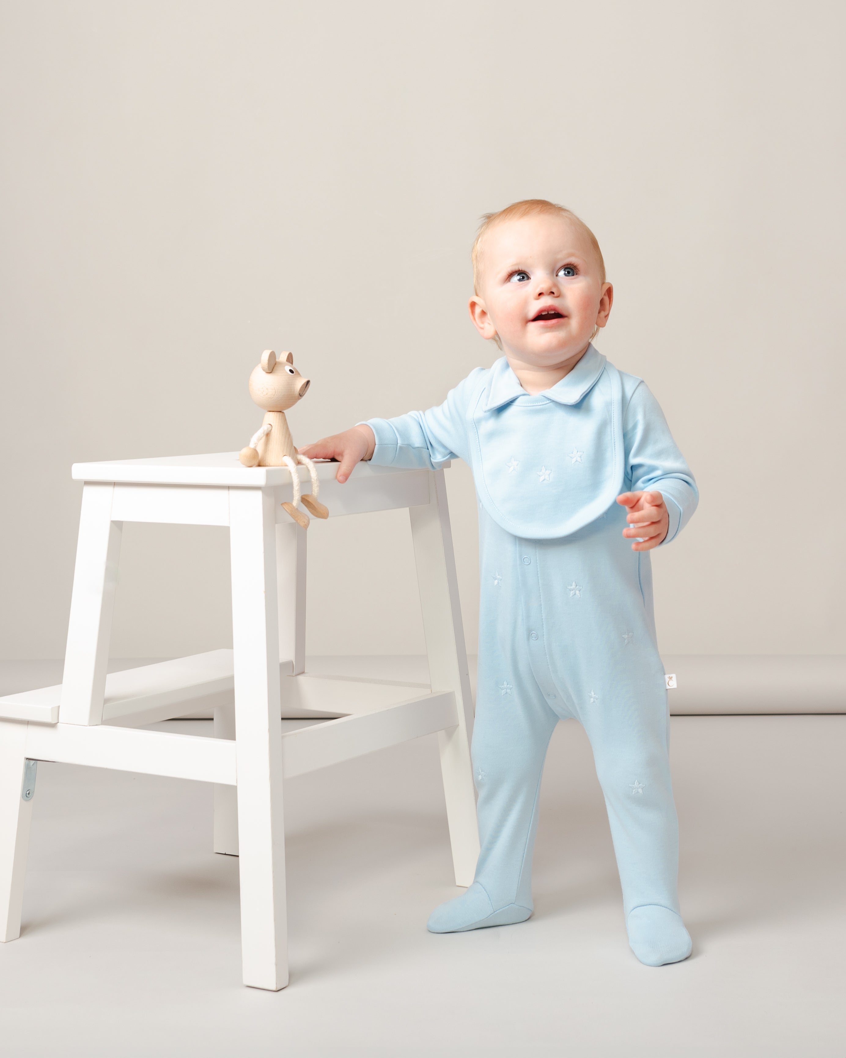 Sky Blue Baby Romper with Embroidered Stars and Matching Bib